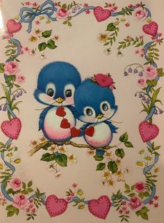 two blue birds sitting on top of a branch with hearts and flowers around the edges