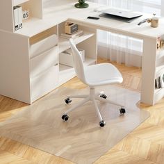 a white desk with a laptop on top of it next to a chair in front of a window