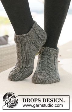 the legs and feet of a woman wearing knitted socks