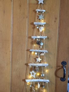 a white christmas tree made out of wooden planks with lights on the top and bottom