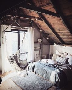 a bedroom with a hammock hanging from the ceiling and lights on the wall