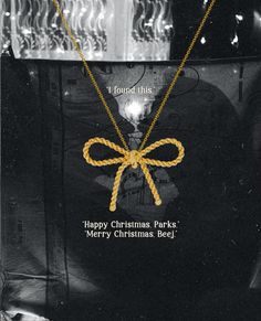 a black and white photo with a yellow ribbon on it's back, saying merry christmas