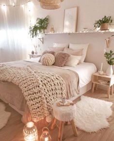 a bedroom with lights and blankets on the bed