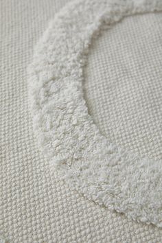 a close up view of the corner of a white blanket