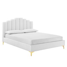 a white bed with gold legs and headboard on it's side, in front of a white background