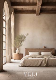 a bed sitting in the middle of a bedroom next to an open window and potted plant