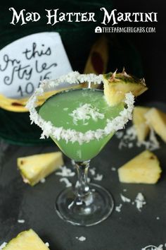 a martini with pineapple and coconut garnish on the rim