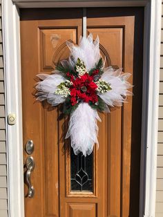 a front door decorated with feathers and flowers