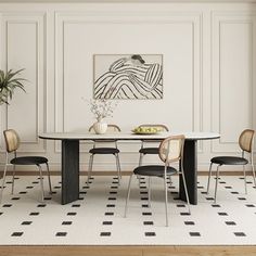 a dining room table with four chairs and a potted plant