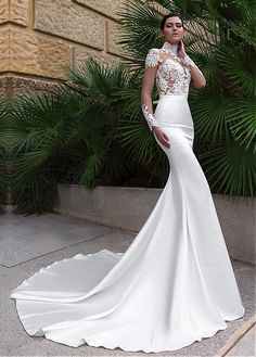 a woman in a white wedding dress posing for the camera