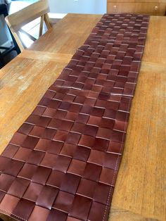 a wooden table topped with a long brown tile flooring line on top of it