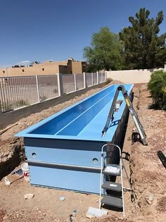 an empty swimming pool in the middle of a construction site with no people around it