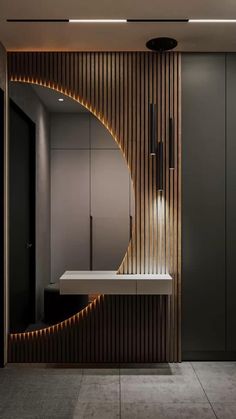 a modern bathroom with wood paneling and lights on the wall, along with a white sink