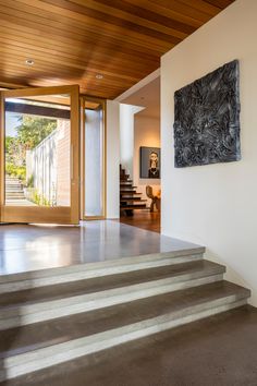 an entryway with concrete steps leading up to the front door