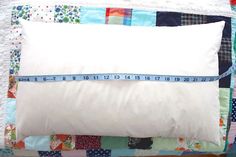 a white pillow with a measuring tape on it