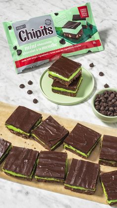 chocolate and mint shortbreads on a cutting board next to a package of chips