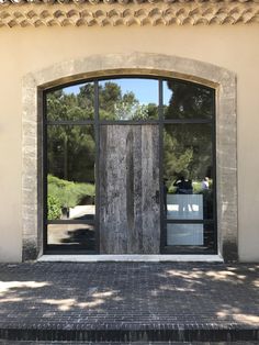 the front door to an old building with large windows