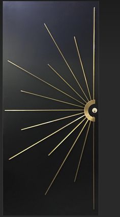 a black door with gold lines and a sunburst design on the front side