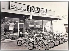 there are many bikes parked in front of the bike shop that sells them for sale