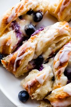 blueberry scones with icing on a white plate