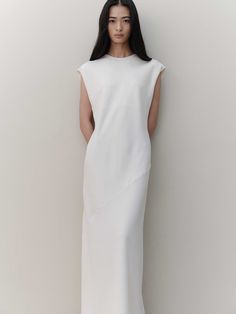 Editor's NotesThe garment is a long dress that exudes understated elegance, perfect for showcasing grace and sophistication. Its back is adorned with subtle shirring, adding a touch of allure and refinement.- The dress's length gracefully covers the body, offering a flattering silhouette.- Crafted with a minimalist design, this piece highlights a sleek and streamlined form.- The long cut of the dress is designed to elongate the figure, providing an elegant and statuesque appearance.Measurements(in.)Size: One Size (XS-M)- Chest: 19.29- Shoulder: 19.69- Total Length: 52.36* Model Tian Liao Info: Height 5'61024 Bust 29.9213 Waist 26.378  Hips 33.8583Composition & Care- 100% Polyester- Cleaning Recommendation: Dry Cleaning Recommended- If washing with water, it is recommended to Formal White Midi Dress With Pleated Back, Elegant Bias Cut Maxi Dress For Daywear, Elegant White Maxi Dress With Pleated Back, Elegant Daywear Dresses With Side Slits, Elegant Bias Cut Dress For Daywear, White Workwear Dress With Pleated Back, Elegant Bias-cut Workwear Dress, White Pleated Back Dress For Work, Minimalist Sleeveless Daywear Dress