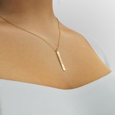 The vertical bar necklace with engraving is a fresh take on the name bar pendant. The vertical pendant design, which can be personalized with the word or name of your choice, will stand out against your other jewelry. Perfect for layering, it can be dressed up or down. Gold Bar Necklace Personalized, Horizontal Bar Necklace, Personalized Name Plates, Arabic Jewelry, Vertical Bar Necklace, Bar Necklace Personalized, Vertical Bar, Turquoise Bead Necklaces, Gold Bar Necklace