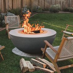 an outdoor fire pit with chairs around it