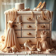 there is a cake made to look like a dresser with shoes and pearls on it