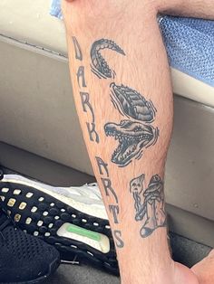 a man's arm with tattoos on it and shoes in the back ground next to him