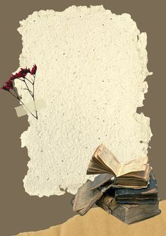 an old book and some red flowers are on top of the torn piece of paper