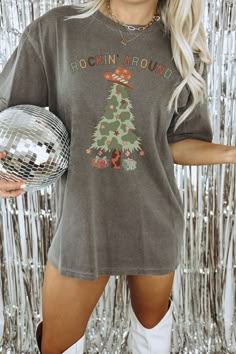 "Get ready to be OBSESSED with your new \"Rockin' Around\" Comfort Colors western Christmas tree graphic tee. It's the cutest and most trendy way to emit all those important cowboy Christmas vibes!  DETAILS * Comfort Colors Garment-Dyed Heavyweight T-Shirt * 100% ring spun cotton  * Design is printed using DTG technology which uses high-quality water-based inks that are printed directly into the fabric.  This means that there may be a slightly faded/vintage look to the design depending on the co Shirts For Women Christmas, Western Christmas Shirt Ideas, Western Christmas Sweatshirt, Western T Shirts Design, Christmas Graphic Print Short Sleeve Tops, Christmas Graphic Tee With Relaxed Fit, Western Christmas Shirts, Winter Graphic Tees, Country Christmas Outfits Women