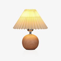 a wooden table lamp with a yellow shade on it's base and a white background