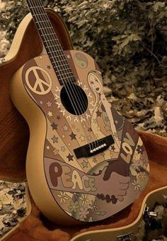 a wooden guitar sitting on top of a case