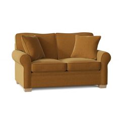 a brown couch with two pillows on the back and one pillow on the armrests