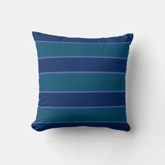 a blue striped pillow on a white wall