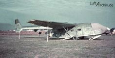 an old airplane is parked on the grass