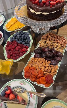 a table topped with lots of different types of desserts