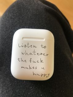 a white button with writing on it that says listen to whatever the fock makes us happy