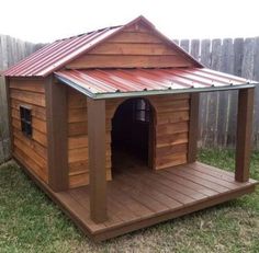 a dog house made out of wood with a red tin roof on the top and bottom