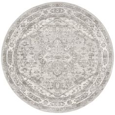 a round rug with an ornate design in grey and white colors on a white background