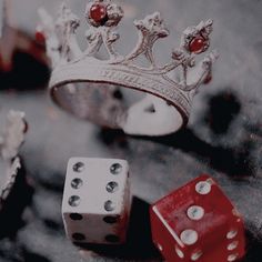 two dices and a crown on a table