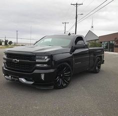 the black truck is parked in the parking lot