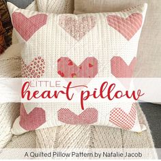 a pillow that has hearts on it and the words little heart pillow written in red