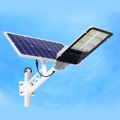 a solar powered street light against a blue sky