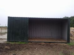 there is a shed that has been dug up in the yard with dirt on the ground