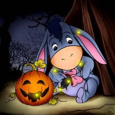 a cartoon bunny sitting next to a pumpkin