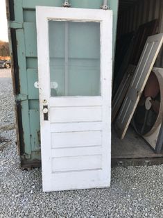 an old door is open next to a pile of junk