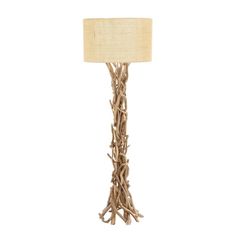 a lamp that is made out of branches and has a white shade on the top