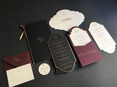 the wedding stationery is laid out on top of each other, including cards and envelopes