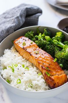 a white bowl filled with rice and broccoli